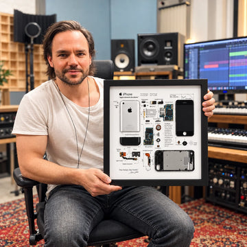 Man holding an iPhone 1st Generation Teardown Frame in a professional music studio